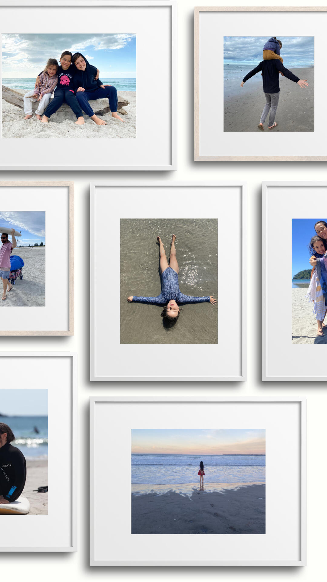 Kinstate Gallery Wall Mockup - Family Photo Display Design A gallery wall mockup showing curated family photographs arranged in white and neutral timber frames